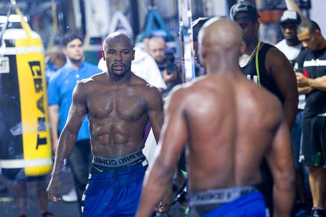 WBC/WBA welterweight champion Floyd Mayweather Jr. looks at his reflection during a media day at the Mayweather Boxing Club Tuesday, Sept. 2, 2014. Mayweather will face Marcos Maidana of Argentina in a rematch at the MGM Grand Garden Arena on Saturday, Sept. 13.