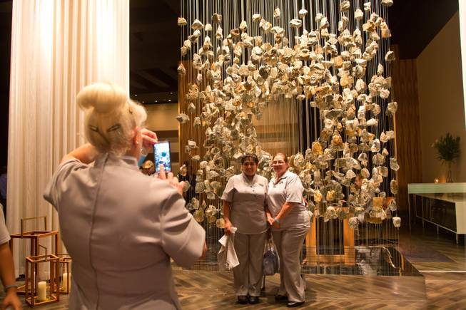 Delano Las Vegas employees pose for a photograph inside the main entrance of their new hotel during a ceremonial opening Tuesday, Sept. 2, 2014.