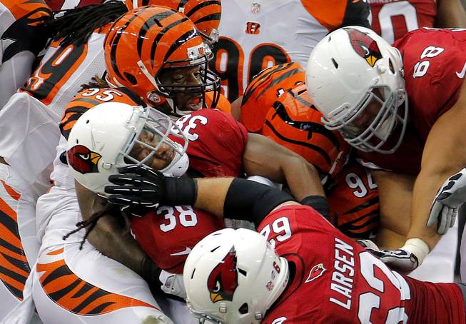 Arizona Cardinals running back Andre Ellington (38) is tackled by Cincinnati Bengals outside linebacker Vontaze Burfict (55) during the first half of an NFL preseason football game, Sunday, Aug. 24, 2014, in Glendale, Ariz. 