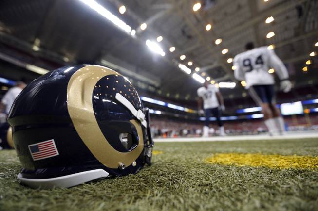 St. Louis Rams defensive end Robert Quinn, right, and Eugene Sims take part in a drill during NFL football training camp at Edward Jones Dome Saturday, Aug. 2, 2014, in St. Louis. 
