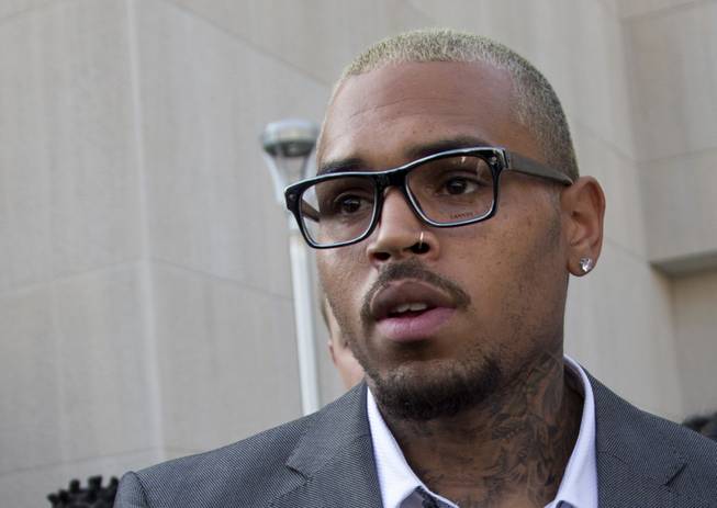 Singer Chris Brown leaves District of Columbia Superior Court in Washington, D.C., on Tuesday, Sept. 2, 2014, after pleading guilty to a misdemeanor assault. Brown pleaded guilty to hitting a man outside a Washington hotel, an assault that occurred while the singer was on probation for attacking his then-girlfriend Rihanna. Brown was sentenced to time served. He spent two days in a D.C. jail in this case. 