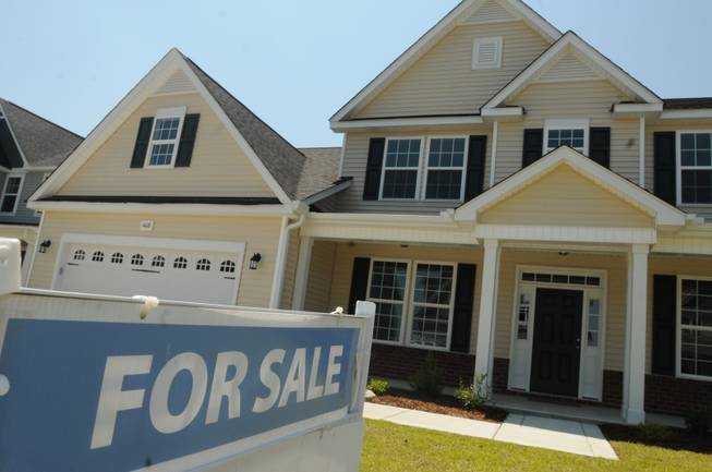 This June 19, 2014, file photo, shows a home for sale in Wilmington, N.C. 