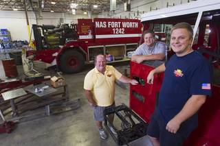 Stuart Reyburn, left, poses with his sons Brian, center, and Dave at Firetrucks Unlimited, 1175 Center Point Dr., in Henderson Wednesday, Sept. 3, 2014. The company refurbishes fire trucks and other fire equipment.