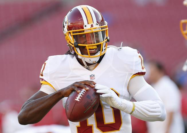  Washington Redskins quarterback Robert Griffin III (10) warms up before the start of a preseason NFL football game against the Tampa Bay Buccaneers Thursday, Aug. 28, 2014, in Tampa, Fla.