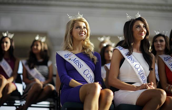 Miss America Pageant contestants Miss Connecticut Acacia Courtney, foreground left, and Miss Colorado Stacey Cookwatch, right, attend arrival ceremonies Wednesday, Sept. 3, 2014, in Atlantic City, N.J. Miss America contestants from all 50 states, the District of Columbia, Puerto Rico and the U.S. Virgin Islands will appear Wednesday at the welcoming ceremony across from Boardwalk Hall.