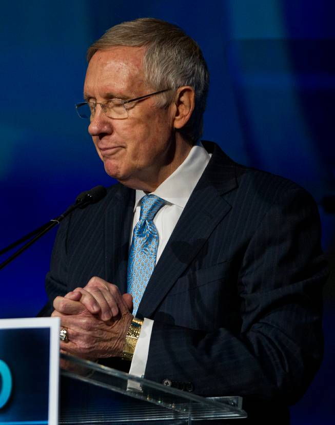 Senate Majority Leader Harry Reid talks about former Secretary of State Hillary Rodham Clinton as she is set to speak during the Clean Energy Summit at the Mandalay Bay on Thursday, September 4, 2014.