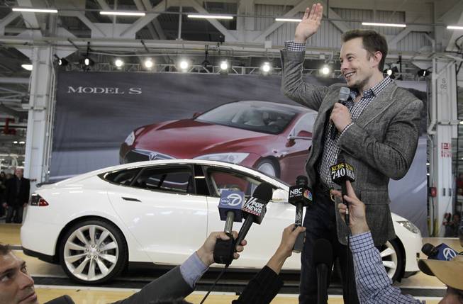 In this June 22, 2012 file photo, Tesla CEO Elon Musk waves during a rally at the Tesla factory in Fremont, Calif. Tesla Motors has selected Nevada for a massive, $5 billion factory that it will build to pump out batteries for a new generation of electric cars, a person familiar with the company's plans said Wednesday, Sept. 3, 2014. 