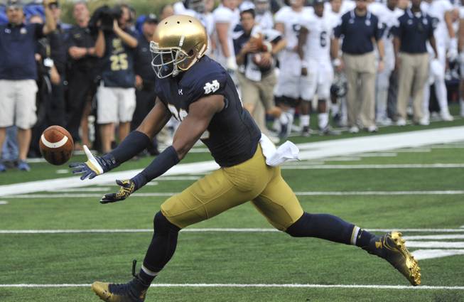 Notre Dame wide receiver C.J. Prosise attempts to make a catch  during a NCAA football game with Rice Saturday, Aug. 30, 2014  in South Bend, Ind.  