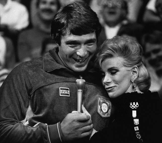 Entertainer Joan Rivers embraces Greco-Roman wrestling gold medalist Jeff Blatnic during the taping of "The Johnny Carson Show," at the NBC Studios in Burbank, Calif., Aug. 11, 1984. Blatnic was one of several members of the U.S. Olympic team that visited the show on Friday. 