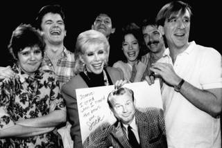 Comedian Joan Rivers, center, holds up a poster of Jack Paar, former host of NBC's 
