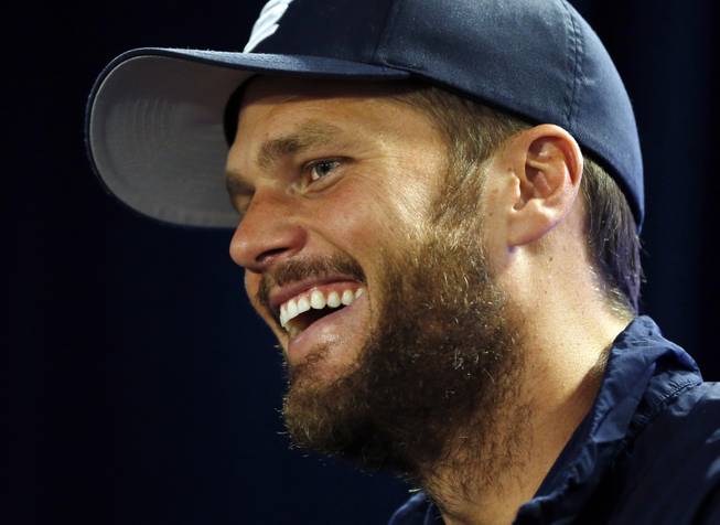 New England Patriots quarterback Tom Brady laughs as he speaks to reporters before team practice in Foxborough, Mass., Wednesday, Sept. 3, 2014. The Patriots are preparing for their opening NFL game against the Miami Dolphins on Sunday in Miami. 
