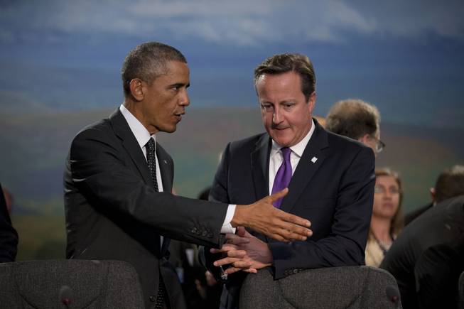 U.S. President Barack Obama and British Prime Minister David Cameron, right, speak before taking their seats at the start of a NATO-Afghanistan round table meeting during a NATO summit at the Celtic Manor Resort in Newport, Wales on Thursday, Sept. 4, 2014. In a two-day summit leaders will discuss, among other issues, the situation in Ukraine and Afghanistan. 