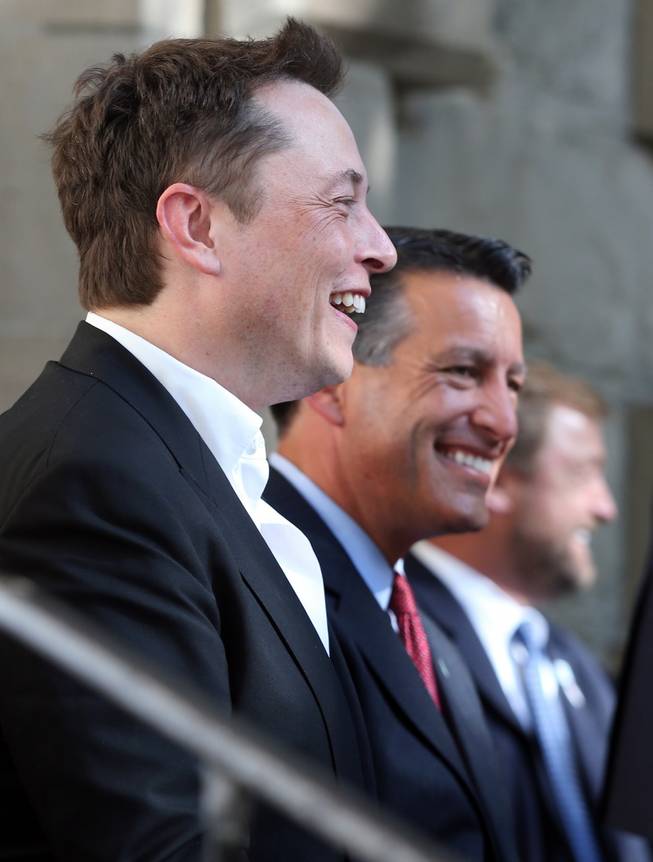 Tesla Motors CEO Elon Musk, left, and Nevada Gov. Brian Sandoval announce Nevada as the new site for a $5 billion car battery gigafactory, during a press conference at the Capitol in Carson City on Thursday, Sept. 4, 2014. 