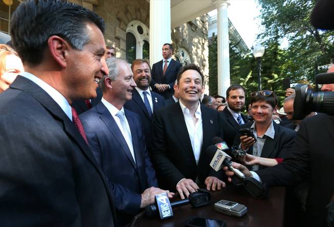 From left, Nevada Gov. Brian Sandoval; Steve Hill, executive director of the Governor's Office of Economic Development; and Telsa Motors CEO Elon Musk answer questions after a news conference at the Capitol in Carson City on Thursday, Sept. 4, 2014.