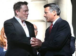Tesla Motors CEO Elon Musk and Gov. Brian Sandoval shake hands after a press conference at the Capitol in Carson City on Thursday, Sept. 4, 2014, in which Nevada was announced as the new site for a $5 billion car battery gigafactory.