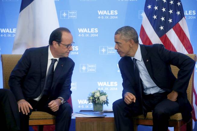 U.S. President Barack Obama meets with France's President Francois Hollande at the NATO summit at the Celtic Manor, Newport, Wales, Friday, Sept. 5, 2014. 