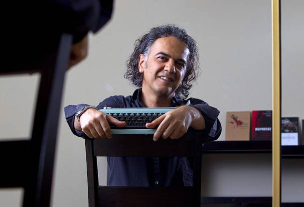 Hossein M. Abkenar, an Iranian fiction writer and screenwriter, poses in his home in Las Vegas Sunday, Sept. 7, 2014. His 2006 novel, A Scorpion on the Steps of Andimeshk Railroad Station, is banned in Iran. It has been translated into French, German and Kurdish.