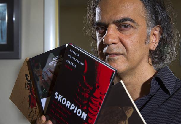 Hossein M. Abkenar, an Iranian fiction writer and screenwriter, poses in his home in Las Vegas Sunday, Sept. 7, 2014. His 2006 novel, A Scorpion on the Steps of Andimeshk Railroad Station, is banned in Iran. It has been translated into French, German and Kurdish.
