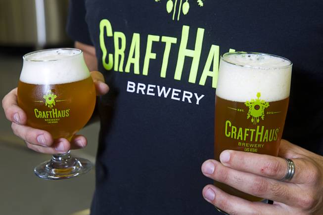 Steve Brockman, brewer in charge of research and development, holds an Evocation Saison, left, and a Resinate IPA at the CraftHaus Brewery in the Henderson Booze District, 7350 Eastgate Rd., Monday, Sept. 8, 2014. The brewery celebrates it's grand opening Friday, Sept. 12.