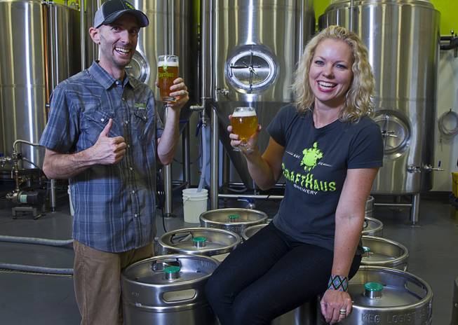 Founders Dave and Wyndee Forrest pose by kegs of beer at the CraftHaus Brewery in the Henderson Booze District, 7350 Eastgate Rd., Monday, Sept. 8, 2014. The brewery celebrates it's grand opening Friday, Sept. 12.