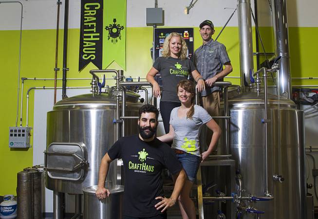 Founders Wyndee and Dave Forrest, top, pose with head brewer Steph Cope and Steve Brockman, brewer in charge of research and development, at the CraftHaus Brewery in the Henderson Booze District, 7350 Eastgate Rd., Monday, Sept. 8, 2014. The brewery celebrates it's grand opening Friday, Sept. 12.