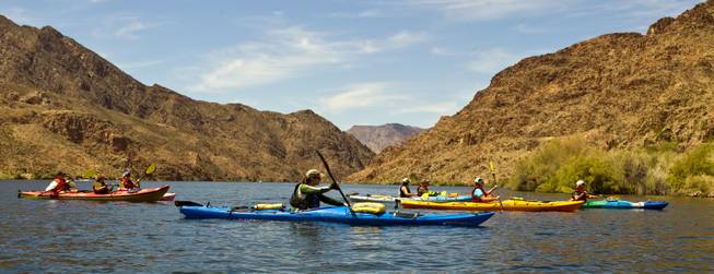 Boats begin to be paddled along during a Colorado River kayak tour with Desert Adventures on Saturday, August 30, 2014.