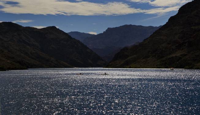 Boats cruise along the glimmering Colorado River later in the day on Saturday, August 30, 2014.