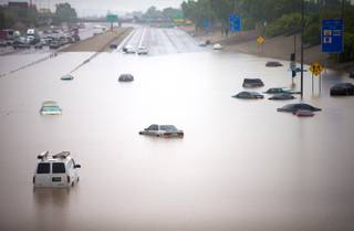 Cars are stuck in flood waters on I-10 east at 43rd Ave. after heavy storms pounded the Phoenix area early Monday, flooding major freeways, prompting several water rescues and setting an all-time single-day record for rainfall in the desert city.