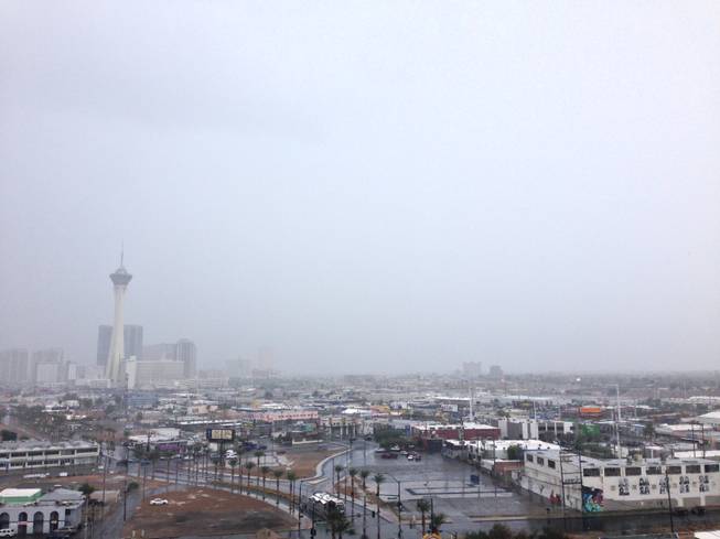 Rain darkens the sky above the Las Vegas Valley toward Las Vegas Boulevard and beyond Monday, Sept. 8, 2014.