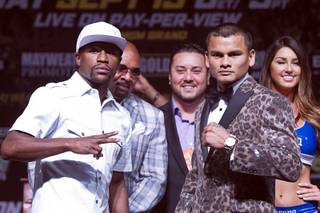 WBC/WBA welterweight champion Floyd Mayweather Jr. and Marcos Maidana attend a news conference at MGM Grand on Wednesday, Sept. 10, 2014. Mayweather will defend his titles, including his WBC junior middleweight title, against Maidana in a rematch at MGM Grand Garden Arena on Saturday.