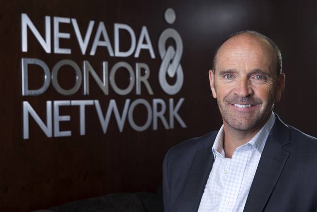 Simon Keith, one of the world's longest living organ transplant recipients and COO of Nevada Donor Network, poses at the Network offices Thursday, Sept. 11, 2014. 