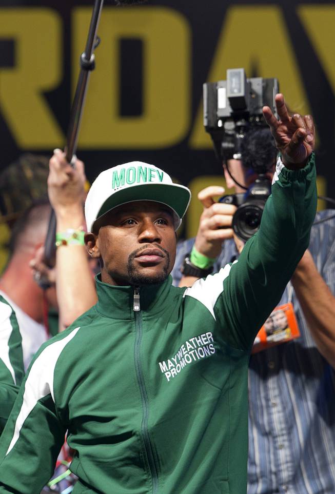WBC/WBA welterweight champion Floyd Mayweather Jr.  arrives for an official weigh-in at the MGM Grand Garden Arena  Friday, Sept. 12, 2014. Mayweather Jr. will defend his titles against Marcos Maidana of Argentina at the arena on Saturday.