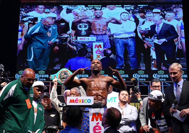 WBC/WBA welterweight champion Floyd Mayweather Jr.  poses on the scale during an official weigh-in at the MGM Grand Garden Arena  Friday, Sept. 12, 2014. Mayweather Jr. will defend his titles against Marcos Maidana of Argentina at the arena on Saturday. Special to the Sun/Richard Brian