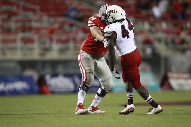 UNLV Rebels offensive linesman Andrew Oberg (73) against Northern Illinois Huskies defensive end Perez Ford (44) during the game at Sam Boyd Stadium Saturday, Sept. 13, 2014.