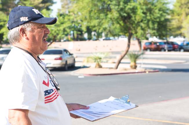 Miguel Amaral attempts to register voters outside the E. Saraha DMV, Friday Sept. 12, 2014. Amaral is a field registrar for Mi Familia Vota, a non-partisan organization that encourages civic engagement among the Hispanic community.
