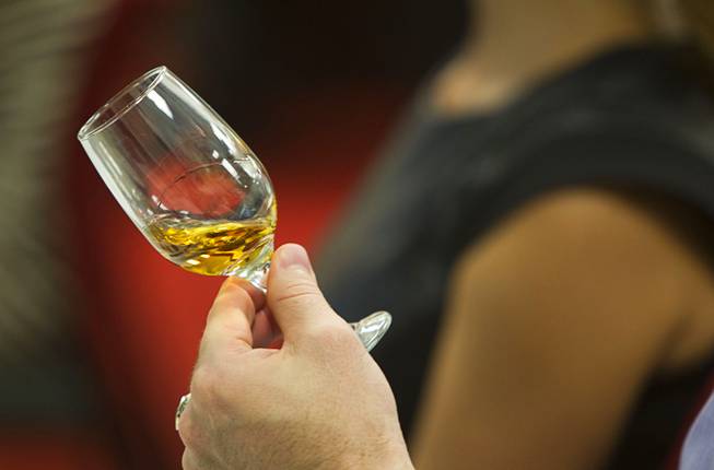 Barton Young holds a sample of whiskey during a Whiskey Boot Camp in the Alchemy Room at Wirtz Beverage Nevada Wednesday, Sept. 17, 2014. The camp was put on by William Grant & Sons, a family-owned Scottish company which distills Scotch whisky and other spirits.