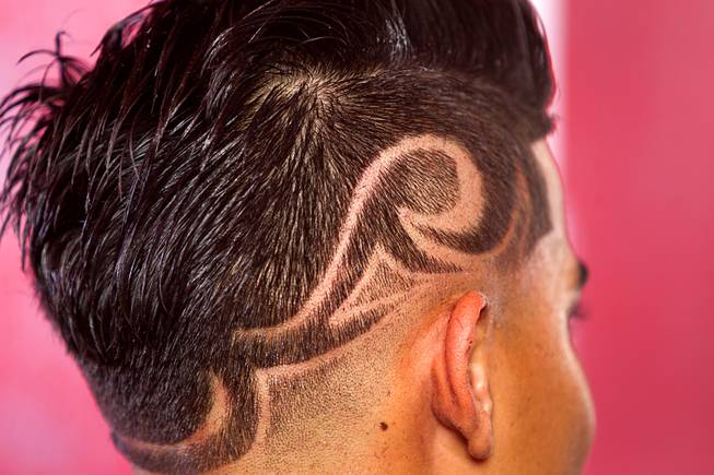 Miguel Rios, 15, gets a razor design cut at Fresh Cuts barbershop, 4533 W Sahara Ave., Thursday, Sept. 18, 2014.