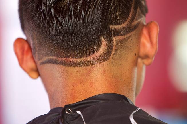 Miguel Rios, 15, gets a razor design cut at Fresh Cuts barbershop, 4533 W Sahara Ave., Thursday, Sept. 18, 2014.