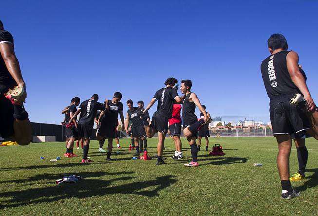 UNLV soccer players Kyle Mellies, center left, and Julian Portugal, center right, stretch at the conclusion of practice at UNLV Thursday, Sept. 18, 2014.