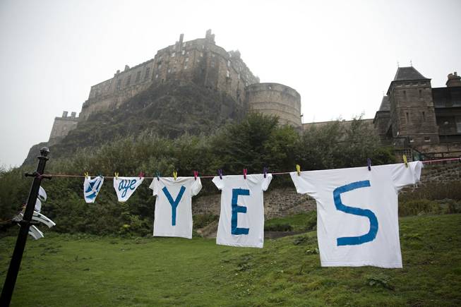 A Yes campaign washing line for the Scottish independence referendum stands backdropped by Edinburgh Castle, in Edinburgh, Scotland, Thursday, Sept. 18, 2014. Scots held the fate of the United Kingdom in their hands Thursday as they voted in a referendum on becoming an independent state.