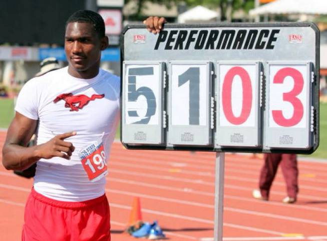 UNLV receiver Devante Davis stands next to a sign displaying his Texas state championship mark in the triple jump in 2011.