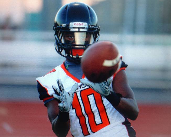 Las Vegas High School football player Elijah Hicks (10) catches a toss before kickoff at Palo Verde, Friday, Sept. 19, 2014.
