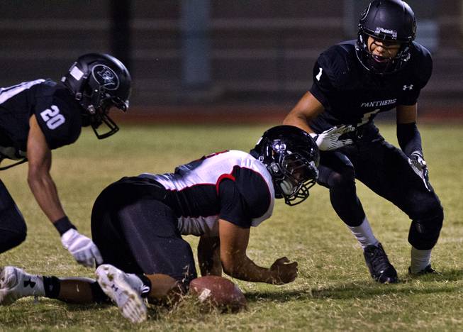 Players eye a loose ball during the Palo Verde versus Las Vegas game on Friday, September 19, 2014.