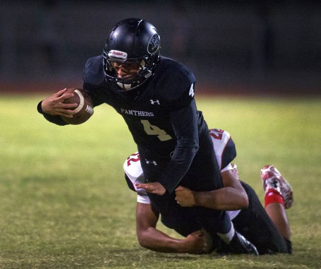 Palo Verde running back .Darrion Finn #4 dives for a few more yards while being taken down by Las Vegas middle linebacker Cruz Littlefield #22 on Friday, September 19, 2014.