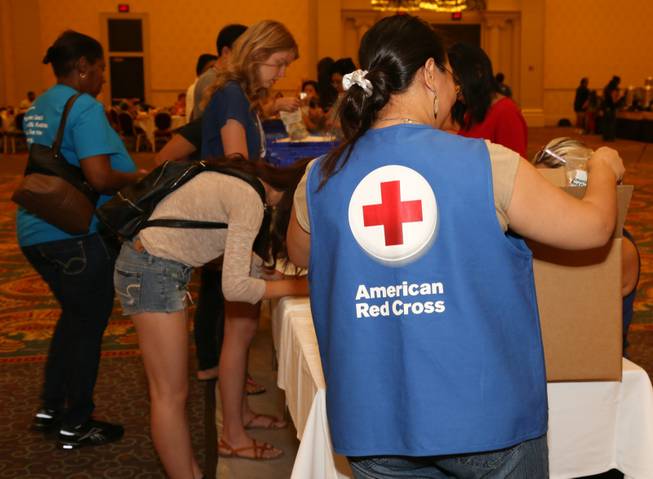 Volunteers build disaster-relief kits through a joint effort by Las Vegas Sands and Clean the World on Saturday, Sept. 20, 2014. The kits will be given to the Red Cross.
