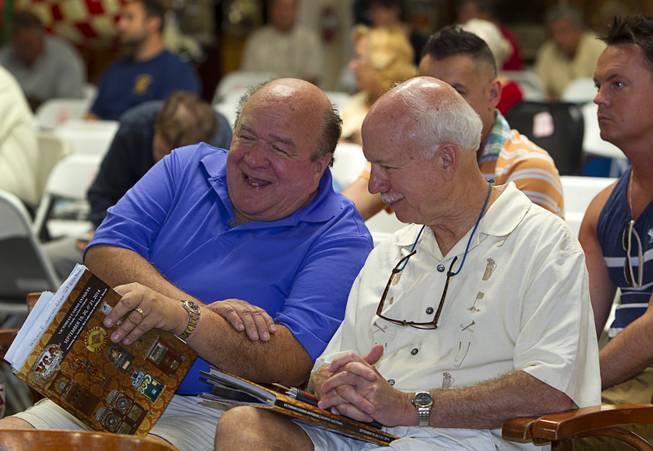 Collectors Larry DeBaugh, left, of Baltimore, MD.,and Steve Kirkwood of Casper, Wyo. wait to bid on antique slot machines during an auction at Victorian Casino Antiques, 4520 Arville St., Sunday Sept. 21, 2014. The William F. Harrah Antique Gambling Machine collection was the centerpiece of a three-day live auction event. The collection included more than 90 upright slot machines, trade stimulators, three-reelers and floor consoles hailing from the late 1800s to the mid-1900s.
