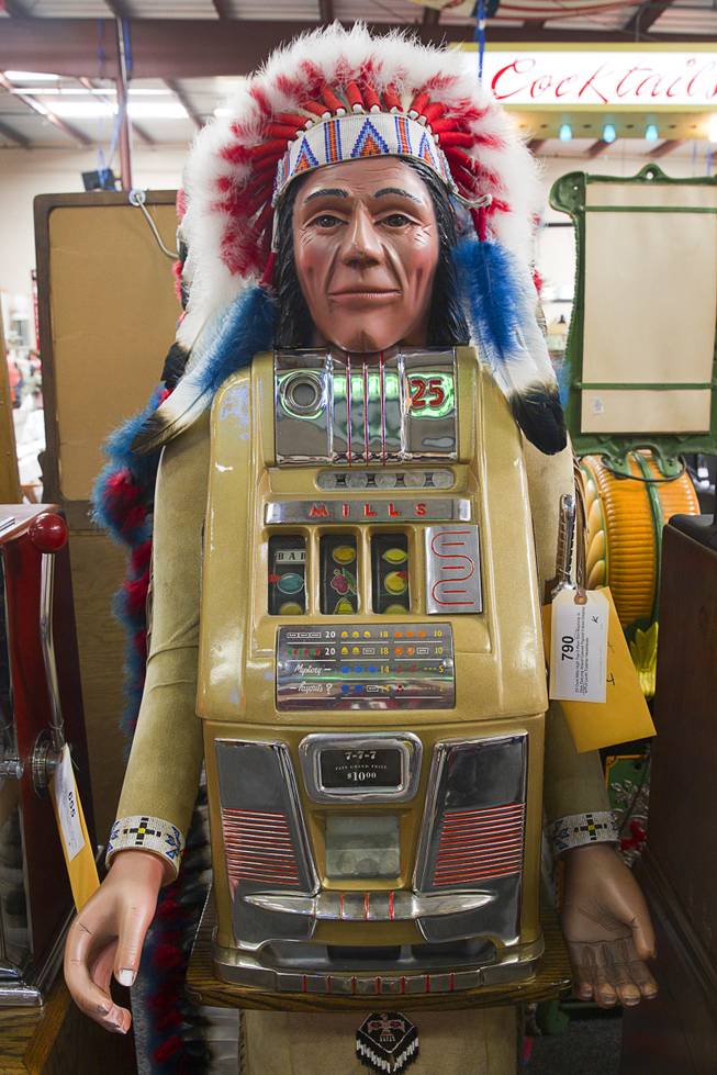 A 25-cent Mills High Top slot machine with Dick DeLong Indian display is shown during an auction at Victorian Casino Antiques, 4520 Arville St., Sunday Sept. 21, 2014. The William F. Harrah Antique Gambling Machine collection was the centerpiece of a three-day live auction event. The collection included more than 90 upright slot machines, trade stimulators, three-reelers and floor consoles hailing from the late 1800s to the mid-1900s.