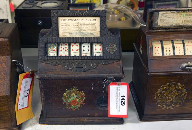 A penny, five-card poker slot machine is displayed during an auction at Victorian Casino Antiques, 4520 Arville St., Sunday Sept. 21, 2014. The machine paid prizes in cigars. The William F. Harrah Antique Gambling Machine collection was the centerpiece of a three-day live auction event. The collection included more than 90 upright slot machines, trade stimulators, three-reelers and floor consoles hailing from the late 1800s to the mid-1900s.