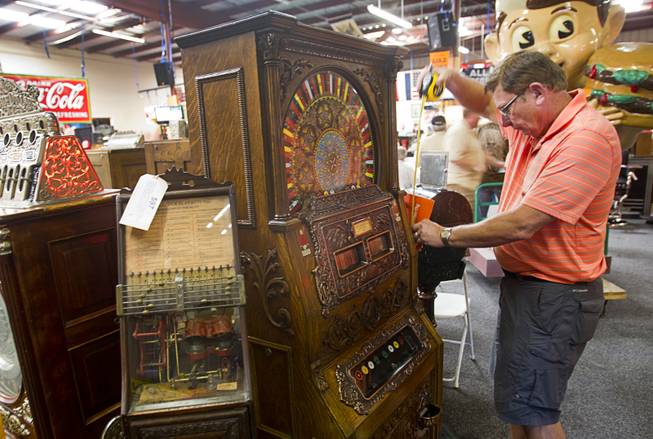 Collector Tom Gustwiller of Ottawa, Ohio takes measurements on an antique slot machines during an auction at Victorian Casino Antiques, 4520 Arville St., Sunday Sept. 21, 2014. The William F. Harrah Antique Gambling Machine collection was the centerpiece of a three-day live auction event. The collection included more than 90 upright slot machines, trade stimulators, three-reelers and floor consoles hailing from the late 1800s to the mid-1900s.