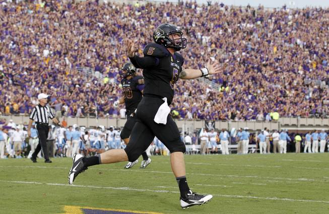 East Carolina quarterback Shane Carden (5) celebrates after throwing a 19-yard touchdown to Brandon Bishop (15) during the first half of North Carolina's NCAA college football game against East Carolina at Dowdy-Ficklen Stadium in Greenville, N.C., Saturday, Sept. 20, 2014. 